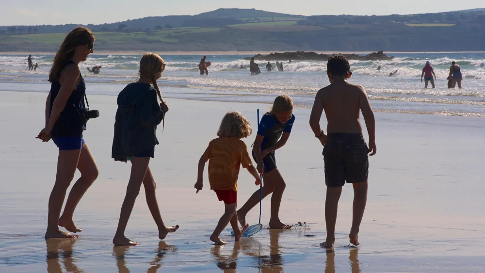 A mother and children on a beach