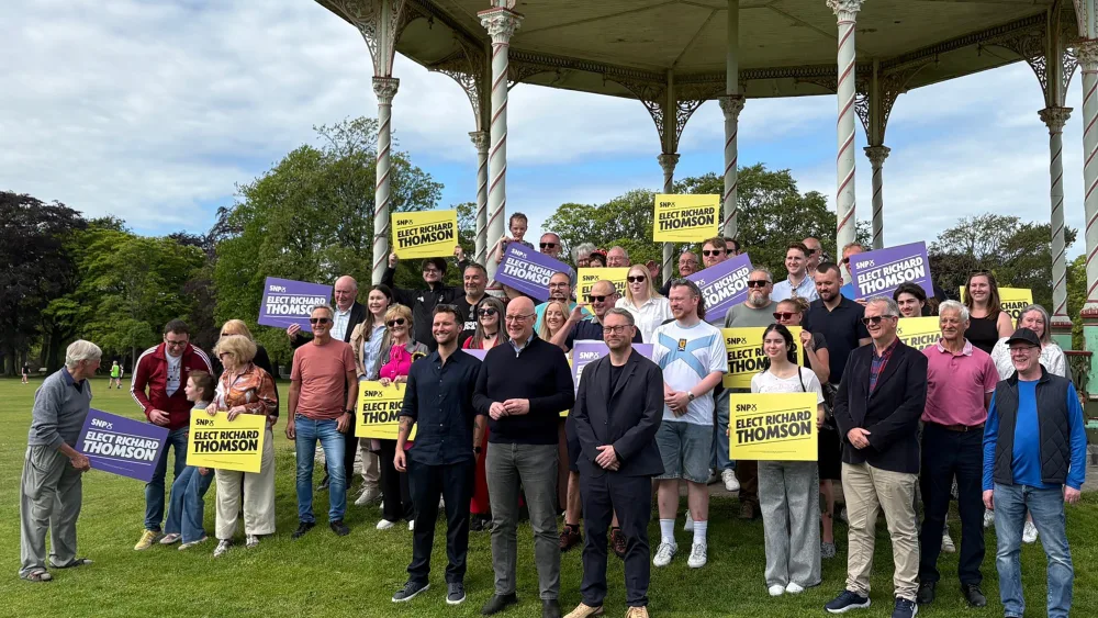 Jack Middleton MSP, John Swinney and Richard Thomson standing in front of SNP supporters