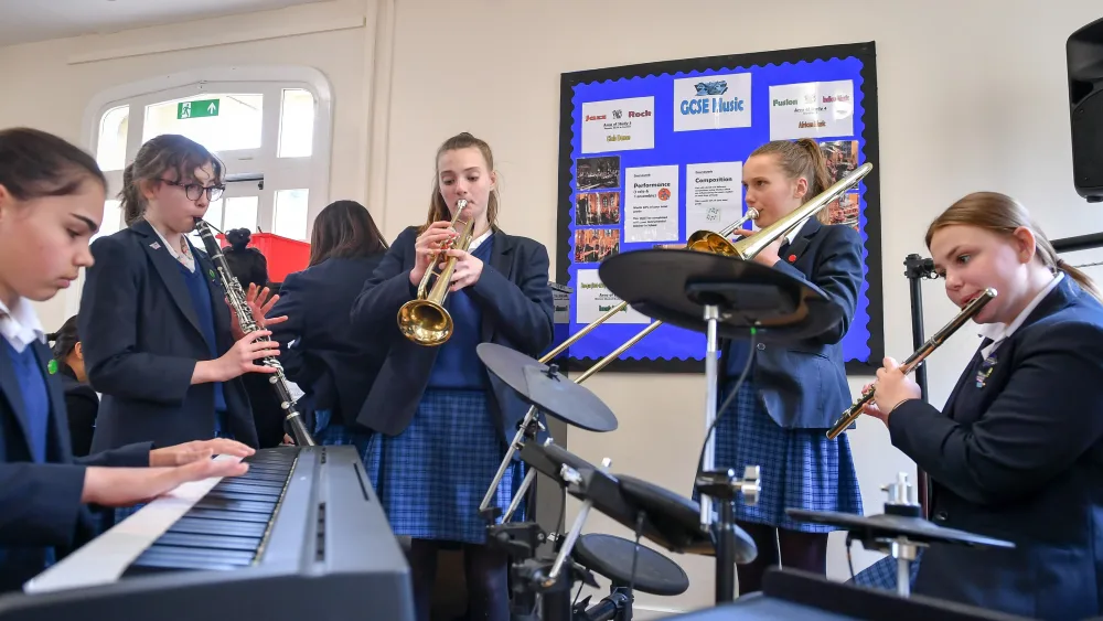 Pupils playing musical instruments in a classroom