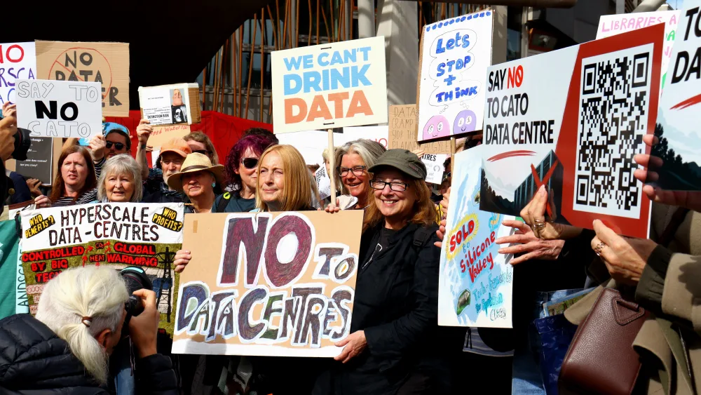 Anti-data centre campaigners at a protest, holding up placards