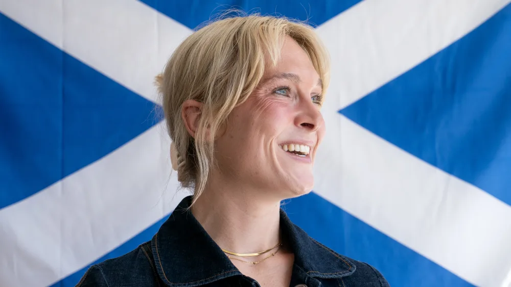 Lara Bird standing in front of a saltire