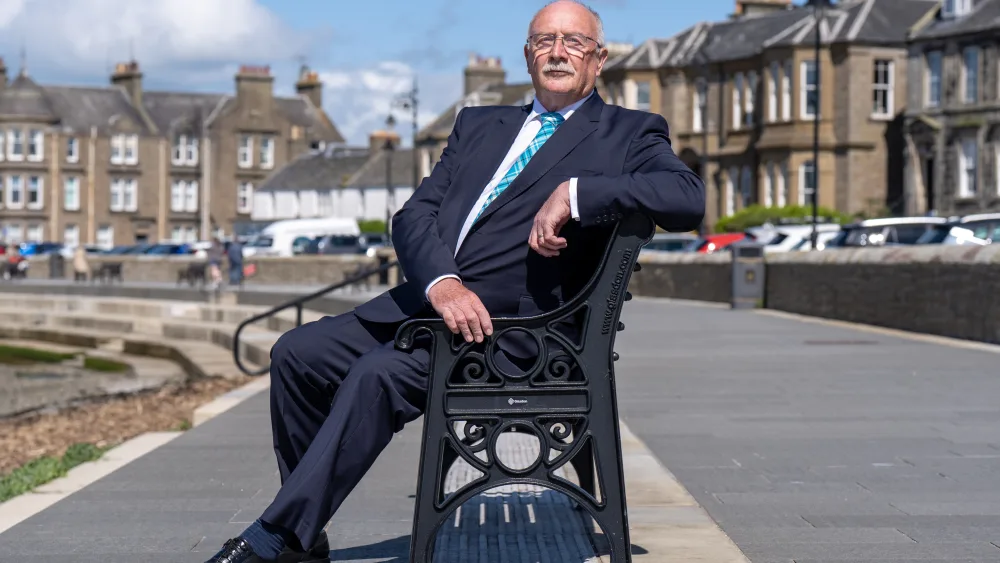 Bill Reid sitting on a bench 