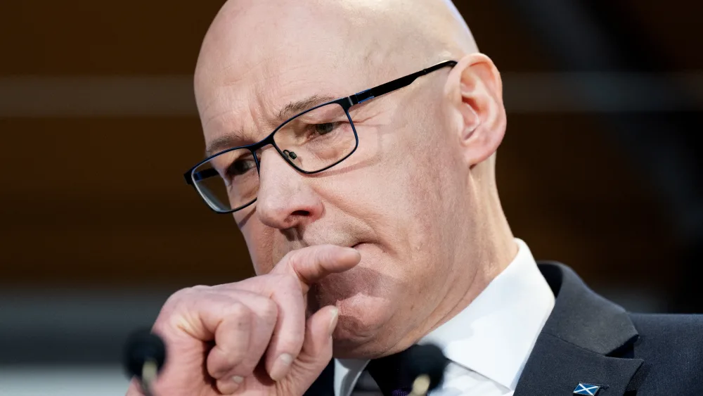Headshot of John Swinney appearing concerned