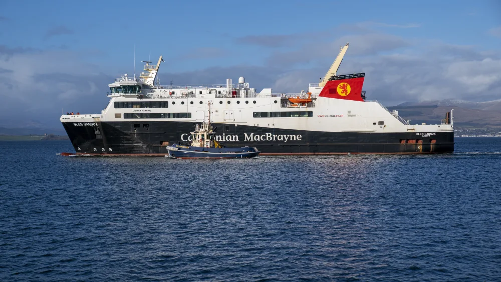 The Glen Sannox ferry at sea, with a tug next to it
