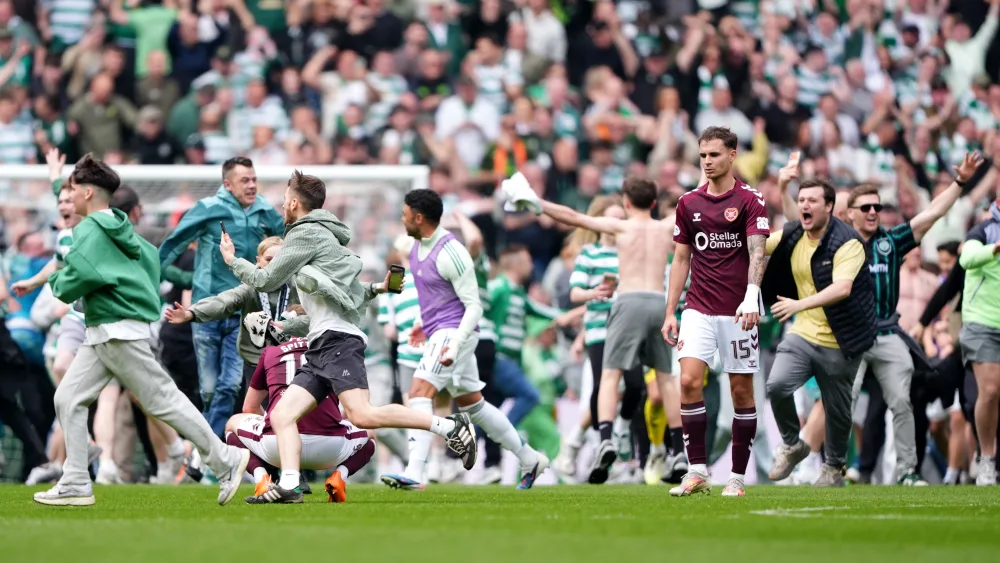 Celtic fans invade the pitch 