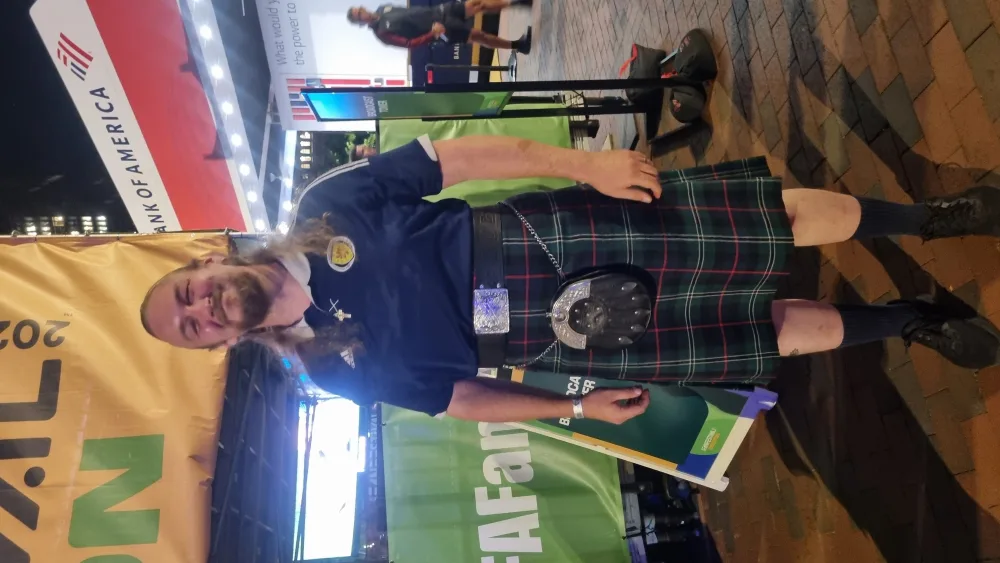 Columba Millander wearing a Scotland shirt and a kilt