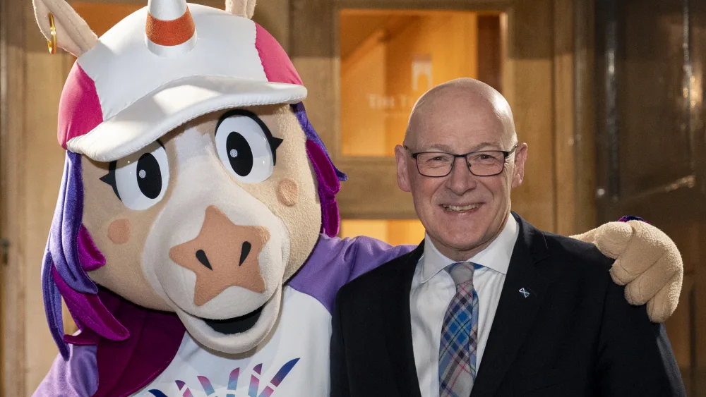 First Minister of Scotland John Swinney with mascot Finnie during a reception at Edinburgh Castle to celebrate the Commonwealth Games being back in Glasgow