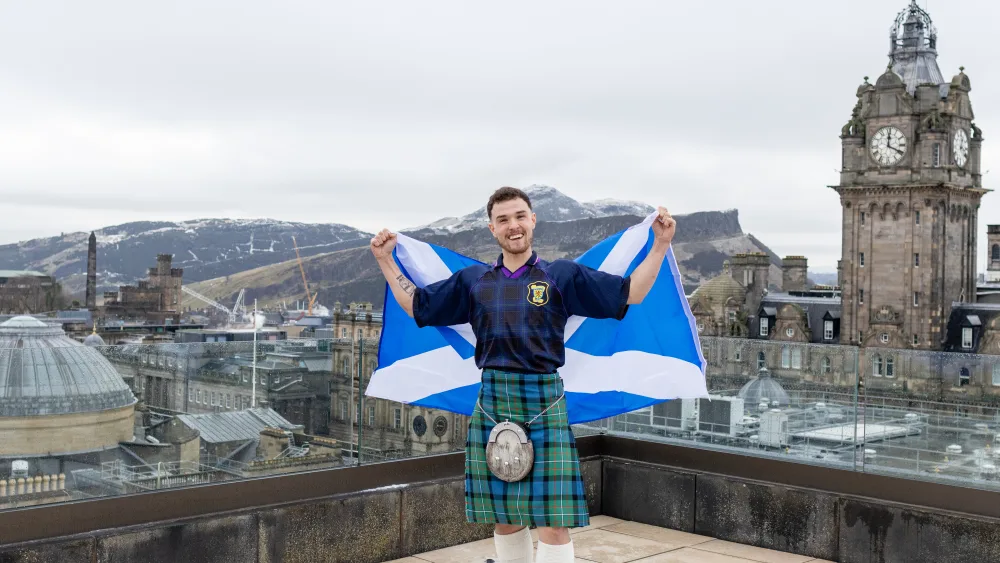Craig Ferguson holding up a Scottish flag