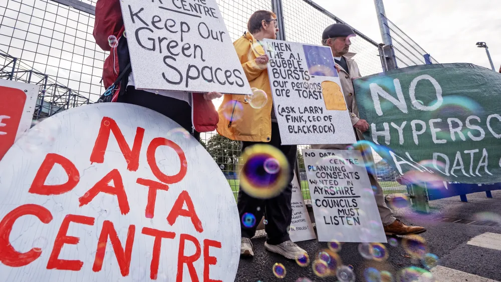 Protesters holding up placards reading 'No data centre' and 'Keep our green spaces'