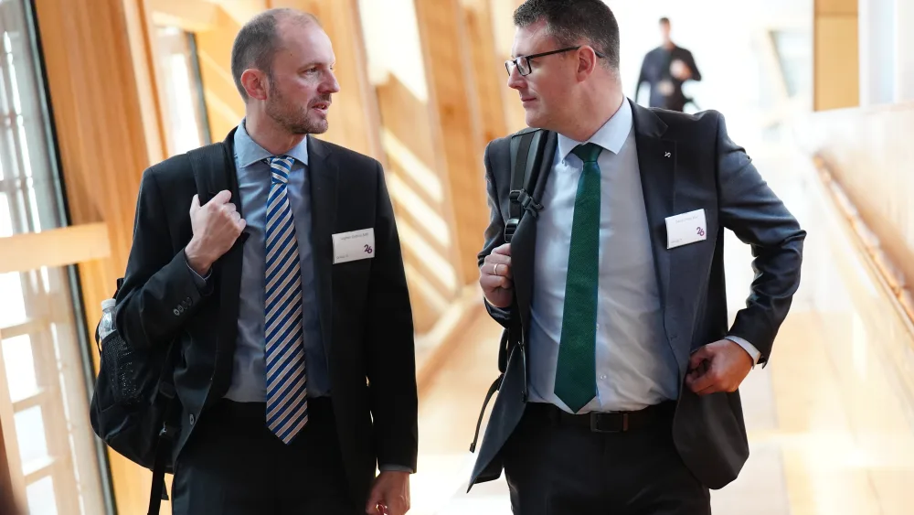 David Linden walking alongside another man in Holyrood