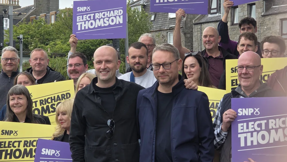 Economy Secretary Stephen Flynn (left) with SNP Aberdeen South by-election candidate Richard Thomson (right) and party activists. (Rachel Keenan/PA)