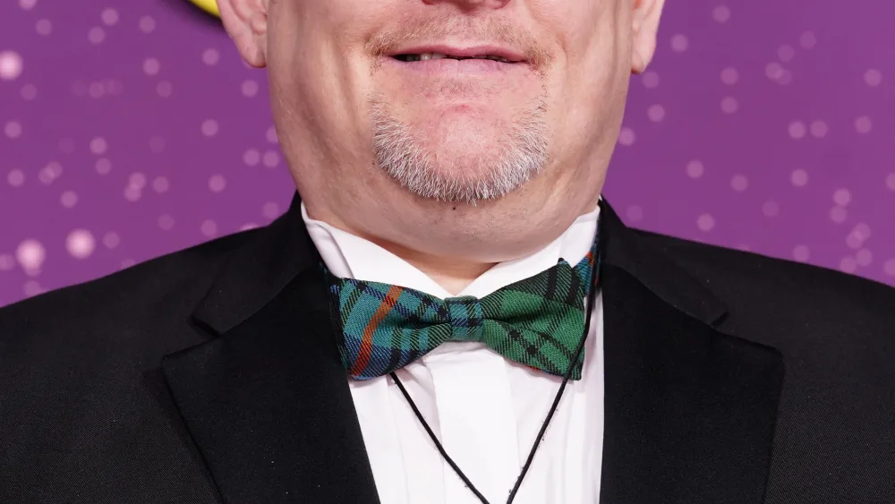 John Davidson smiling, wearing a suit
