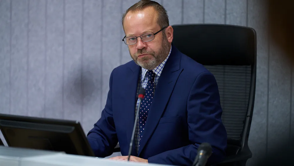 Lord Weir seated as chairman of the inquiry