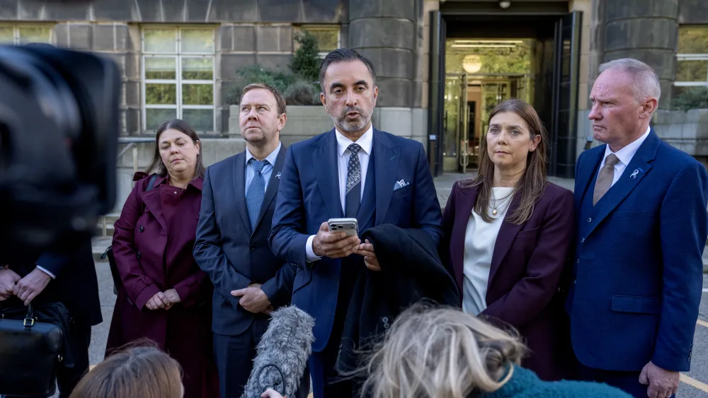The family of Ethan Scott Brown standing outside a building