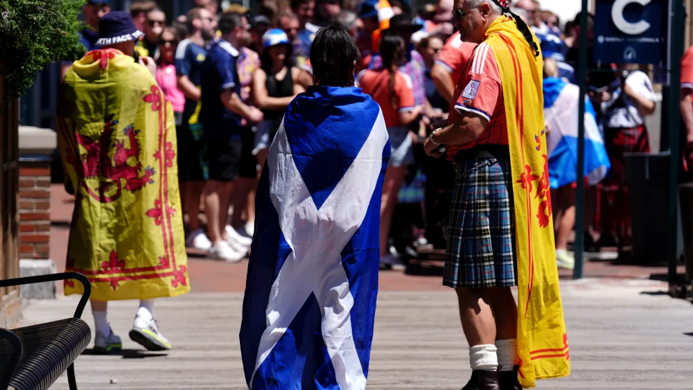 Fans have been draped in flags ahead of the match (Andrew Milligan/PA)
