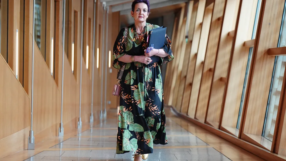 Angela Constance walking through a corridor at Parliament