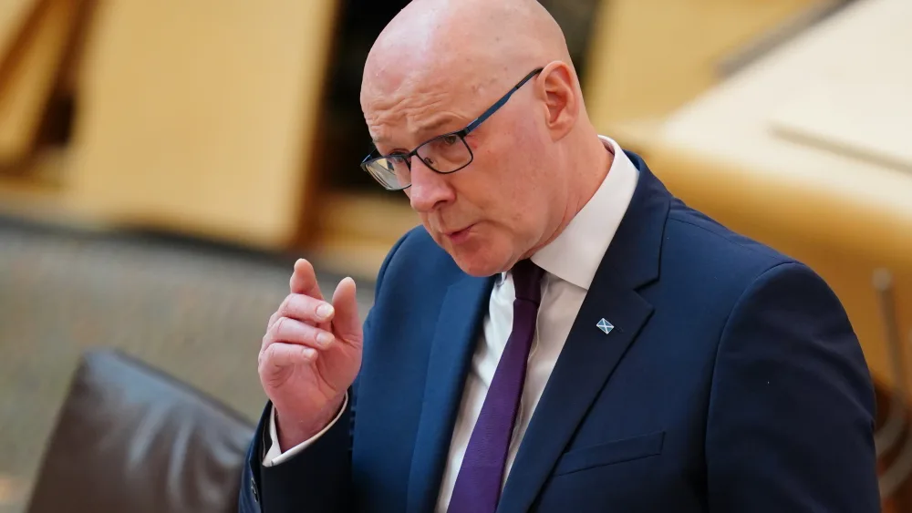 John Swinney standing while speaking in Holyrood