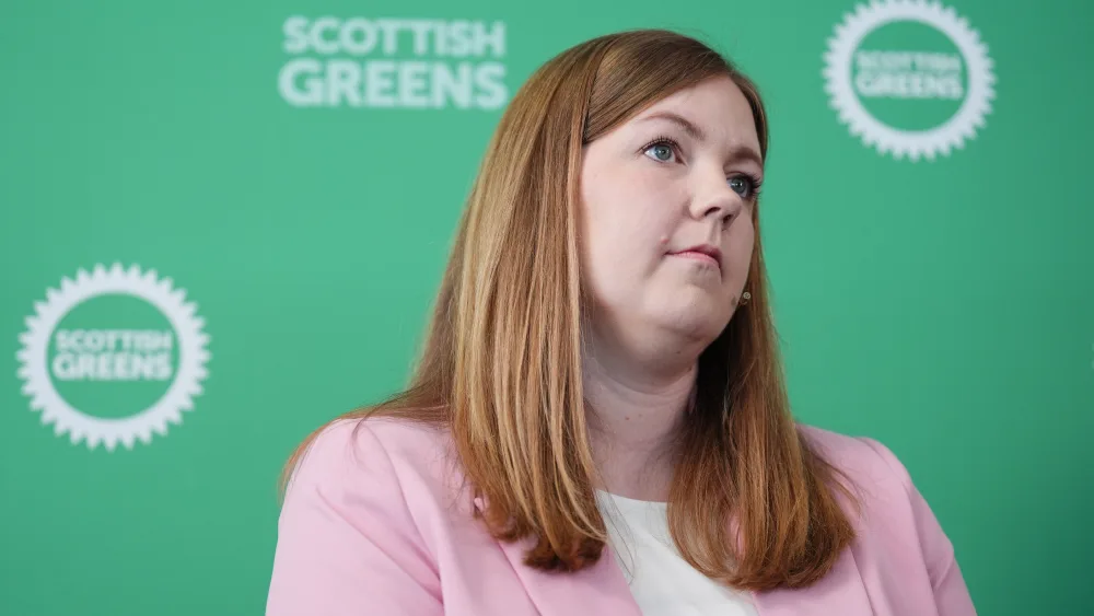 Gillian Mackay in front of Scottish Green signage