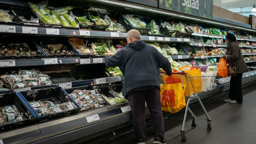 Someone at the fruit n' veg section of a supermarket