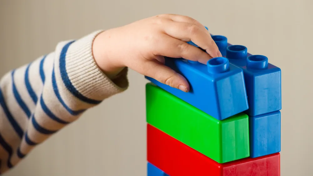 A child building a tower with blocks