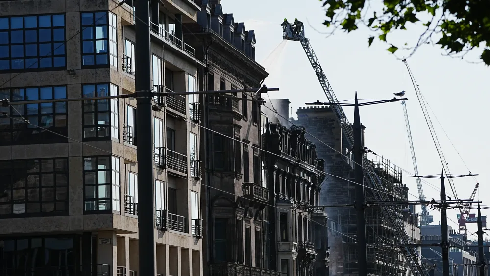 View of firefighters on a high platform tackling a building fire
