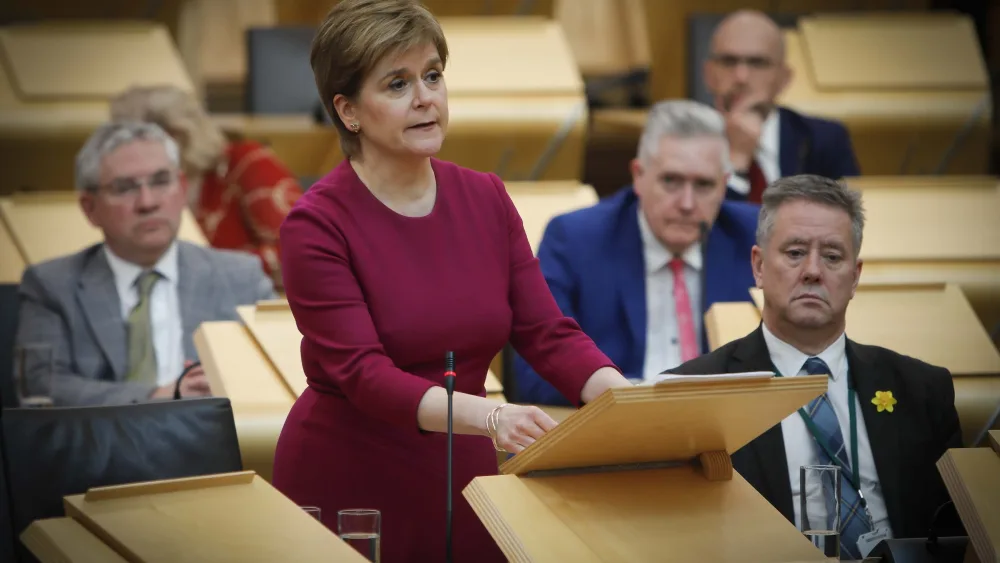 Nicola Sturgeon standing while speaking in Holyrood