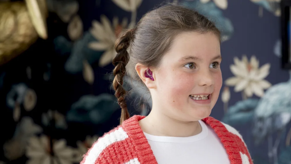 Iona Fagerson, 7, pictured with her new hearing aid