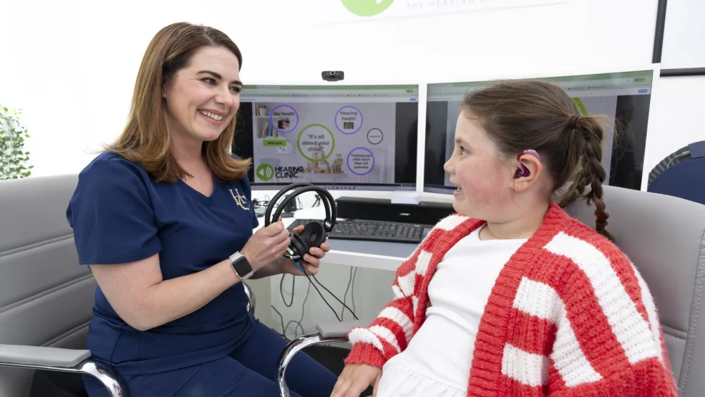 Iona Fagerson, 7, pictured with senior audiologist Dominique Stone at The Hearing Clinic UK's clinic in Milngavie