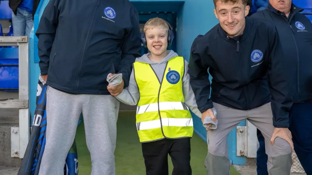 Jacob McDonald, at Inverness Caledonian Thistle with the family who walk each ground beside him dad Kenny, godfather Stuart Carter and grandson Alexander. (Family Handout/PA)