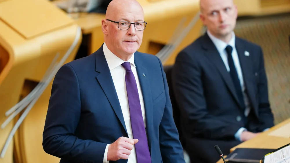 John Swinney standing while speaking in Holyrood