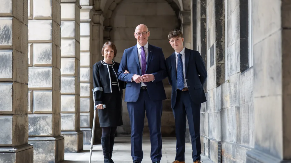 John Swinney with his wife and son outside the Court of Session