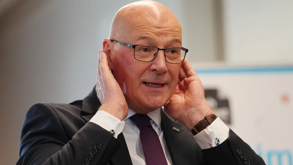 John Swinney listens during a visit to a reading group Bookbug session