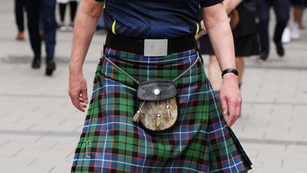 John Swinney wearing a kilt and Scotland top