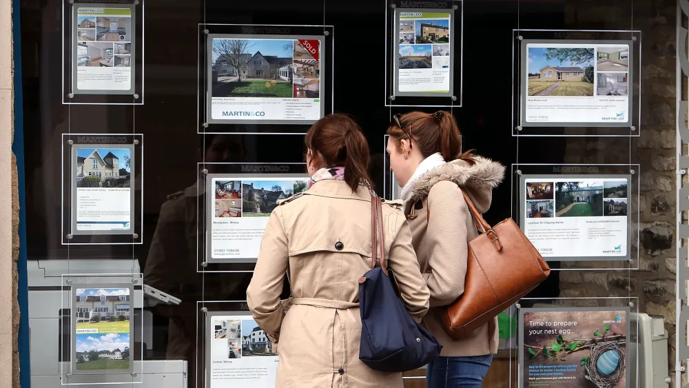 Young people at an estate agent's