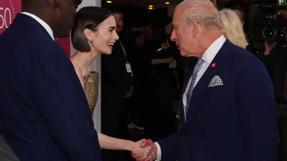 Lily Collins shakes hands with the King 