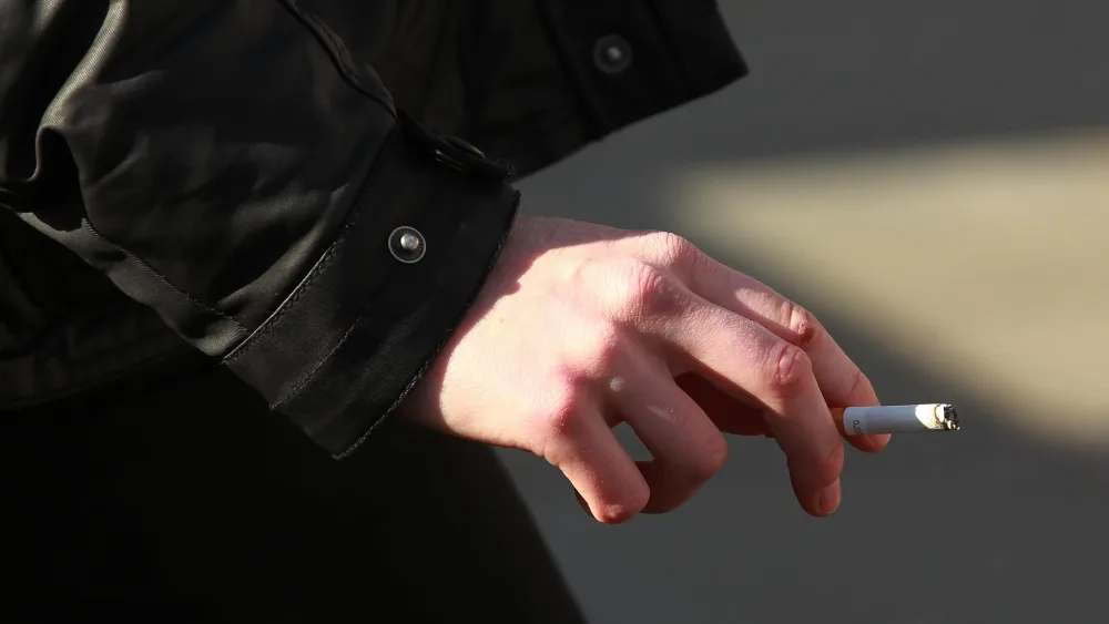 A hand holding a cigarette