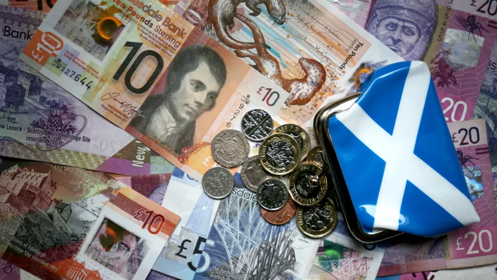 Scottish banknotes, with coins and a Saltire purse on top of them