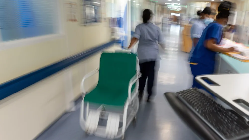 A chair being wheeled down a hospital corridor