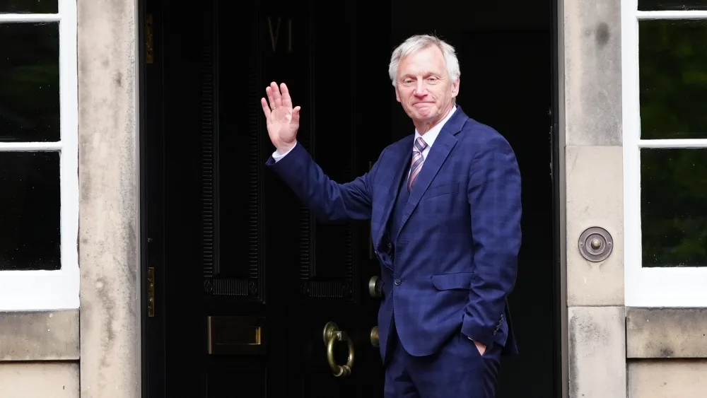 Ivan McKee waving outside Bute House
