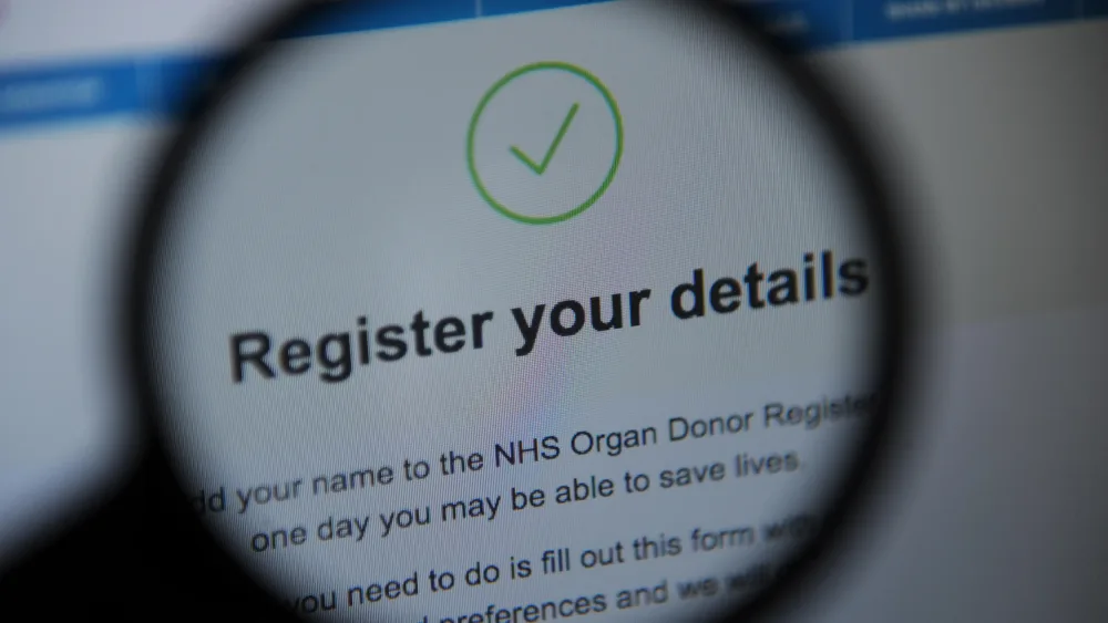 The NHS Organ Donor Register online seen through a magnifying glass