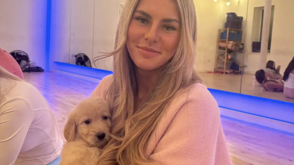 Ami Robertson holding a small dog