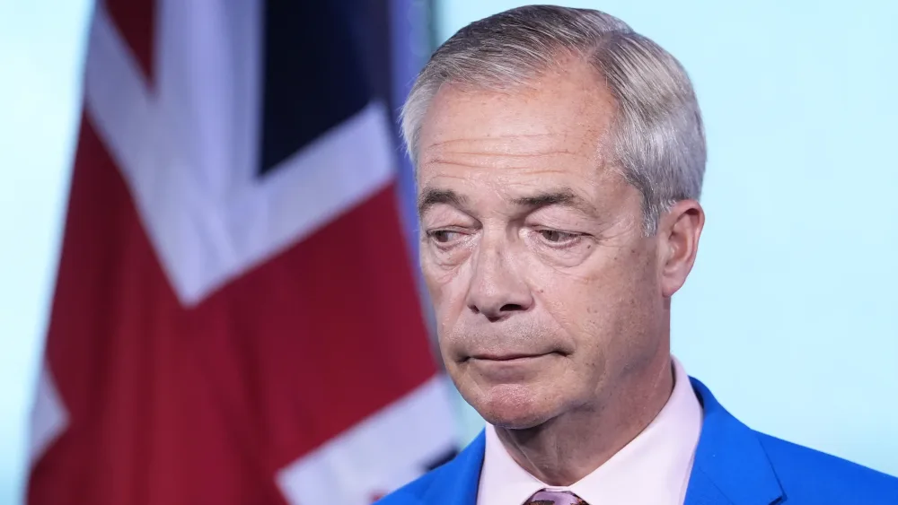 Headshot of Nigel Farage, in front of a British flag