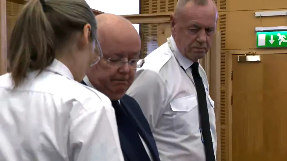 Peter Murrell in court, flanked by two custody officers
