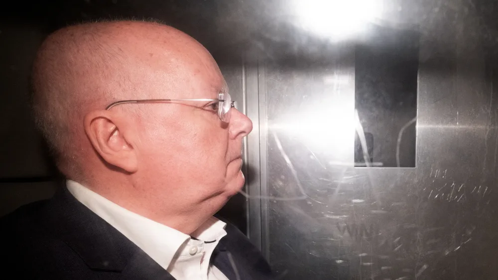 Side view of Peter Murrell in the back of a prison van