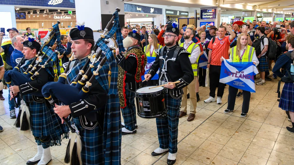 Pipers playing in an airport terminal