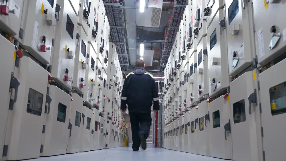 A person walking through a large data centre