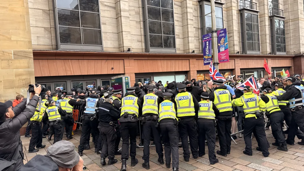 Police pushed back counter-protesters who attempted to break the barriers in Glasgow (Craig Meighan/PA)