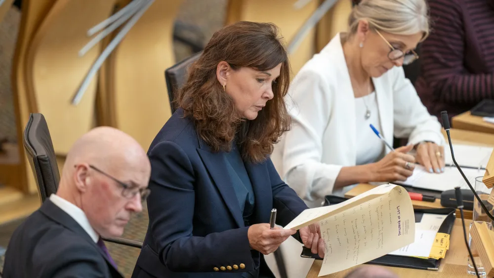 Dorothy Bain seated on the Government benches at Holyrood