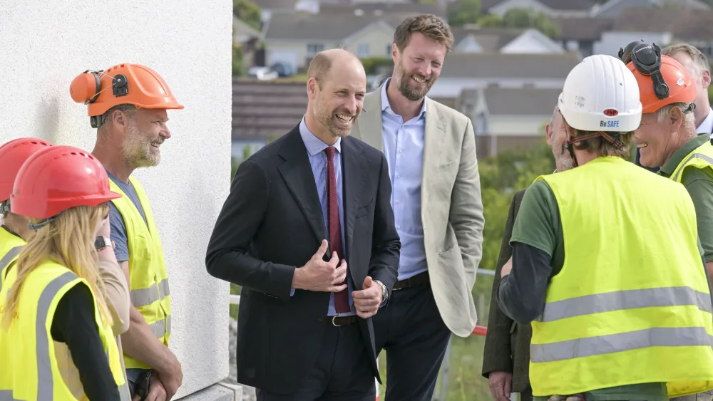 The Prince of Wales speaks  with staff during a visit to a Duchy of Cornwall housing development in Tretherras, Cornwall, to mark the final stages of a project that includes homes purpose-built to address homelessness