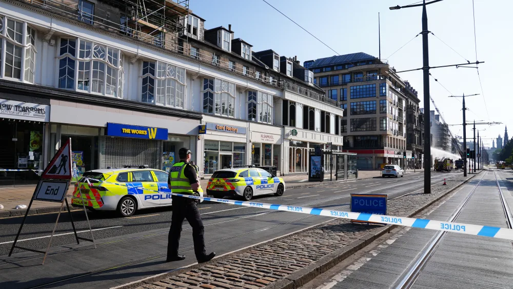 A police officer at the start of a police cordon on Prices Street